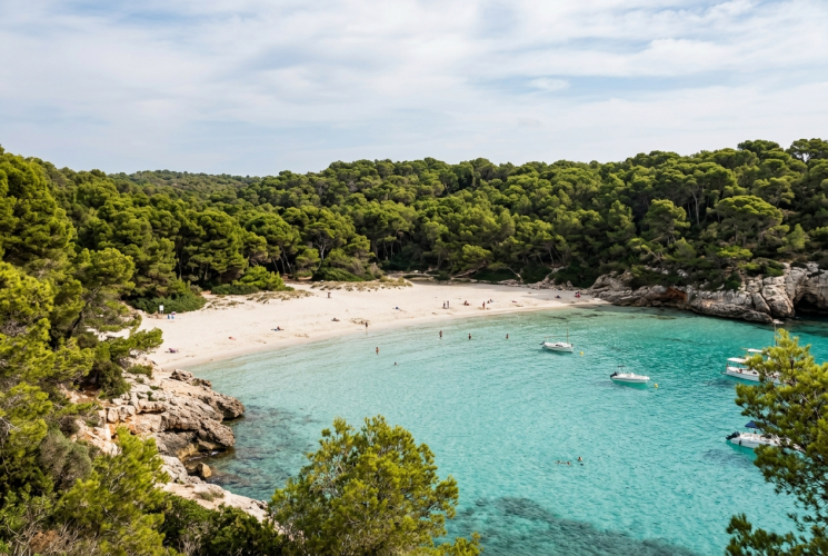 Cala Trebaluger secluded white sand beach and pine forest in Menorca Spain